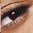 A close-up pixelated image of a human eye with visible eyelashes, eyebrow, and skin tones.