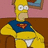 Pixelated cartoon character with yellow skin, white eyes, blue cape, red and orange chest emblem, and white briefs, seated against pink and brown background.
