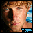 A pixelated image of a person with light brown hair and blue eyes, wearing a blue and white striped background with text "TREY" at the bottom.