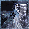 A fairy with long dark hair and translucent wings stands in a misty, rocky cave with a waterfall, wearing a flowing light blue gown.