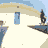 Animated contact sheet showing a skater performing tricks on a rooftop against white buildings with blue doors and light brown roofs under a pale blue sky.