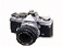 A black and silver digital camera icon with a lens, showing sequential animation frames with white and yellow X overlays on the lens area.