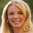 Static 48x48 pixel icon showing a close-up of a smiling person with long blonde hair against a blurred green background, rendered in low-resolution pixel art style with visible dithering and color blending.