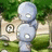 Pixelated image of a light blue humanoid figure with white circular eyes and a small mouth, standing in front of a green and beige background with a circular symbol on the left.