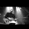 A black-and-white of 25 distinct System of a Down images showing band members, album art, and concert scenes with visible text elements