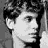 A black-and-white pixelated image of a person's face next to bold pixelated text reading "I wanna run through the walls of my high school" on a white background.