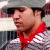 Static 50x50 pixel icon showing a person in profile wearing a red scarf and gray jacket with white stripes, set against a blurred background.