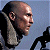 A pixelated contact sheet showing two frames of an animated icon featuring a bald man in profile and green text on a dark background.