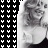 A black-and-white animated icon shows a woman with curly hair smiling, wearing a dark top and light-colored garment, positioned against a patterned background.