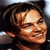 Pixelated close-up of a person with dark hair, closed eyes, and a slight smile against a dark background.