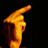 Animated contact sheet showing six sequential frames of a person in yellow clothing performing hand gestures and singing into microphones against dark background.