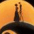 Animated icon shows two silhouetted figures walking on a crescent moon against an orange sky, with text changing across frames.