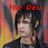 Pixelated image of a person with dark hair and light skin, wearing a black top against a blurred background with red and yellow tones.