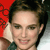 Pixelated close-up of a person with short dark hair, light skin, and a slight smile, set against a red and white background.