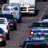 Static image of multiple cars in a traffic jam, viewed from above with various vehicle colors and positions.