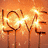 A pixelated orange background with the word 'LOVE' in glowing letters, transitioning to display 'Gabi' in bright pink text.