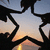 A star-shaped icon with black outline and gradient fill showing sunset sky, featuring a central star with a small dark shape at its top-left corner.