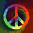 Rainbow-colored peace symbol icon with gradient fill on dark background, featuring red orange yellow green blue purple hues.