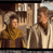 Static pixelated image of two figures in a dimly lit interior with wooden structures and vertical beams, rendered at low resolution.