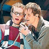 Two people in a close pose with one holding a microphone, text changes from 'friends' to 'just friends?' across frames.