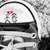 A grayscale cartoon character with a red heart above its head, positioned under an arched structure.