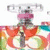 A colorful animated icon with a central figure in a pink headpiece and dark clothing, surrounded by swirling red, green, and blue patterns on a white background.