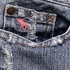 A static image of a denim pocket with a pink moose logo on the fabric, surrounded by faded blue and gray denim texture.