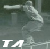 Pixelated static icon showing a light-colored figure in motion with white text "TA" at the bottom against a dark green background.