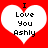 Two identical white heart shapes on a red background, each containing black pixelated text reading "I Love You Ashly" with the 'I' positioned above the heart.