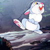 A cartoon rabbit with white fur, blue limbs, and pink inner ears sits on a gray log, mouth open in a shout, eyes wide with yellow and blue irises.