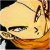 Pixelated close-up of a character's face with yellowish skin, dark eyes, and brown hair against an orange background.