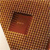 A pixelated brown and red icon with a dark curved shape on the left side and a lighter brown background.