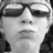 Black-and-white pixelated image of a person with dark hair and sunglasses, yellow text overlay reading "I Love This Guy!" on the right side.