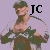 Pixelated image of a person in military-style clothing holding a weapon, with large black letters 'JC' on the right side against a light purple background.