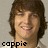 Pixelated portrait of a smiling person with brown hair, wearing a light-colored shirt, with the text 'coppie' in black pixelated font at the bottom left.