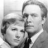 Black-and-white pixelated image of two people in close proximity, one with short hair and the other with longer styled hair, both facing forward.