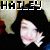 Pixelated image of a person with dark hair and light skin, wearing a dark top, with the name 'HAILEY' in pixelated text above.