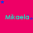 A bright pink background with repeated cyan text 'Mikaela' and scattered blue stars in a