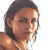 Pixelated close-up of a person with short dark hair, light skin, and a neutral expression, cropped to show shoulders and upper chest against a white background.