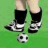 Pixelated soccer player legs in black socks and white cleats kicking a ball on green grass, with text overlays showing 'SOCCER PLAYERS KICK GRASS' and red X marks over the word 'GRASS'.