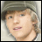 Two side-by-side frames of a pixelated animated buddy icon showing a person with light brown hair wearing a gray cap and white shirt, first facing forward then tilted to the right.