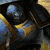 Animated icon shows armored figure with helmet and sword, transitioning to close-up of helmeted face with text "Enim Gloriam" and red "Ad...Infinium" banner.