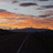 Pixelated landscape showing orange and gray sky transitioning to dark water with a diagonal line across the lower portion.