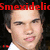 Pixelated close-up of a person's face with dark hair, red text overlay, and dark background.