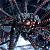 Pixelated static image with abstract dark background and scattered red/pink light spots, appearing as a low-resolution digital art or glitch effect.