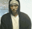 A person wearing a dark hoodie and white shirt appears in with varying background lighting conditions