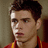 Pixelated image of a person with dark hair wearing a red and yellow garment, next to red pixelated text reading "matthew lawrence <3" on a white background.