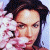 A pixelated image of a person with dark hair holding pink flowers against a light background, next to green text reading 'Original Icons .com' on a solid green backdrop.