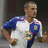 Pixelated image of a person in sports attire with a rose emblem and text overlay on striped background.