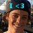 Two side-by-side pixelated images of a person wearing a dark cap with blue text above each head, one reading "I <3" and the other "RYAN", both smiling against an outdoor background.